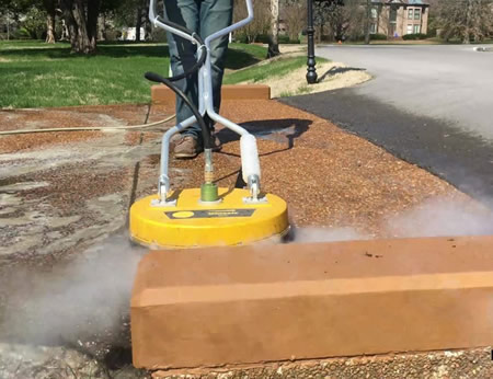 Hot water surface cleaner removing oil stains from a Nashville driveway