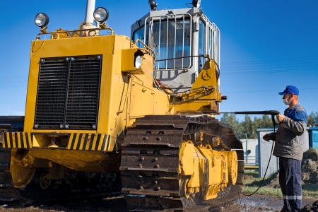 technician washing an excavator at a nashville tn jobsite
